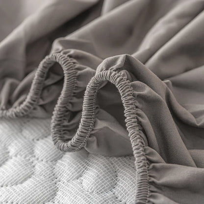 Gray fitted sheet with elastic band on a mattress