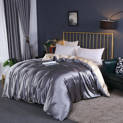 Bedroom with a bed featuring gray bedding and gold headboard.