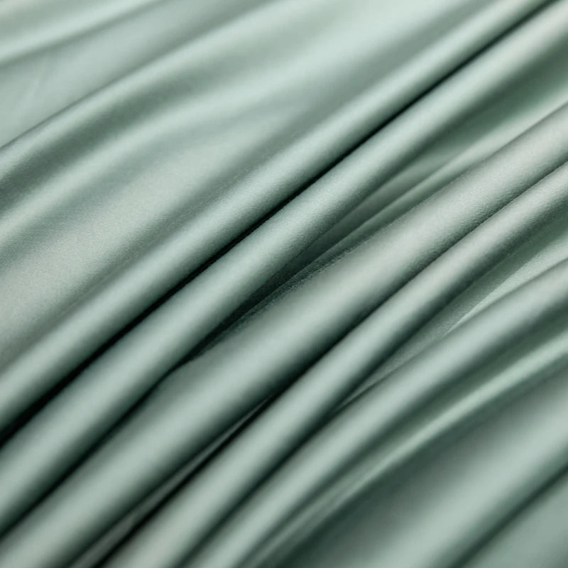 Close-up of light green fabric with folds