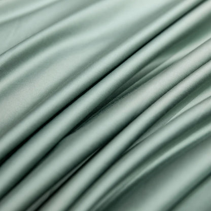 Close-up of light green fabric with folds