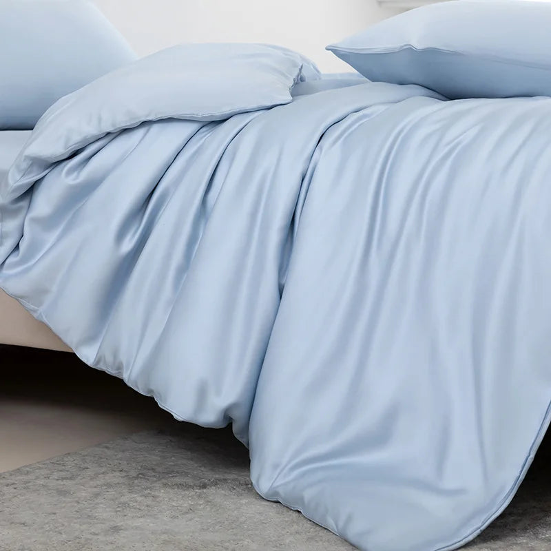 Light blue bedding set on a bed with a neutral background