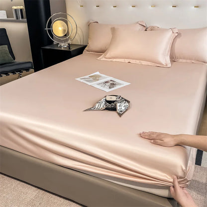 Person adjusting a satin sheet on a bed in a bedroom setting