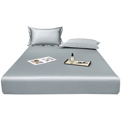 Gray bed sheet set with pillows on a white background