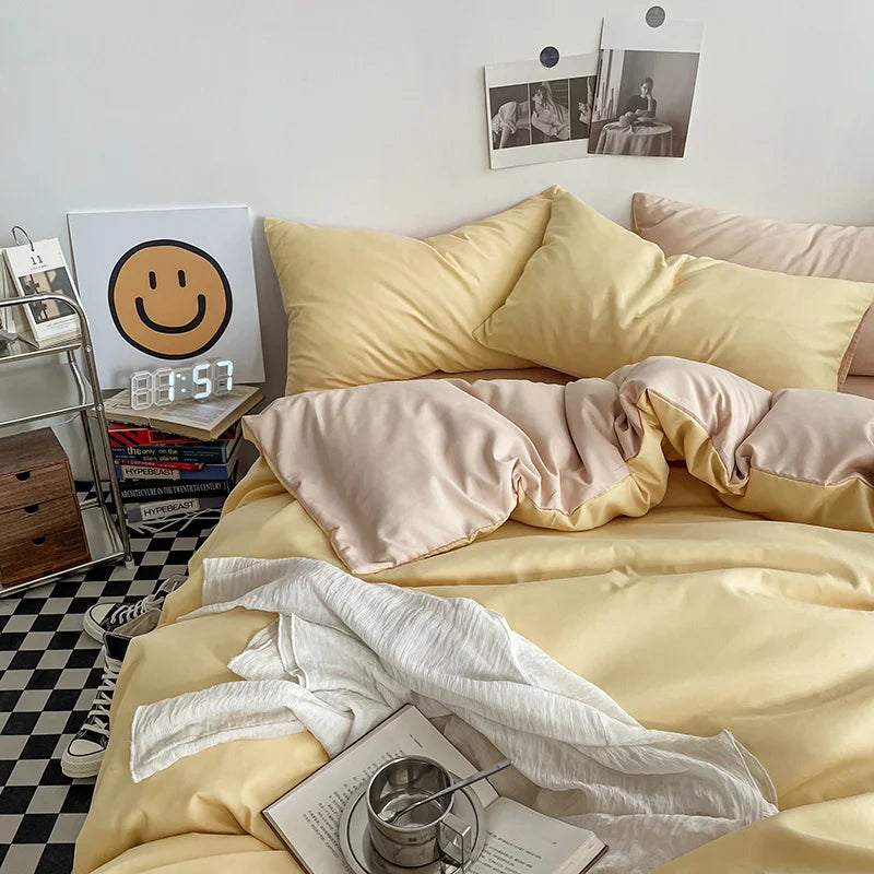 Bedroom with yellow bedding and a smiley face clock on a nightstand.