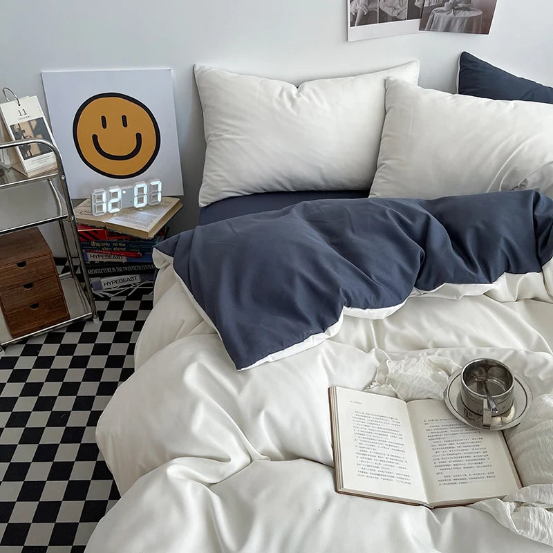 Bedroom with white bedding, a smiley face clock, and a book on a checkered floor.