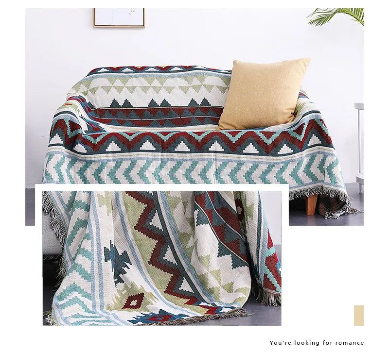 Geometric patterned throw blanket draped over a couch with a pillow.