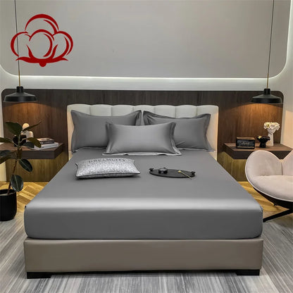 Modern bedroom with a bed featuring gray bedding and a decorative headboard.