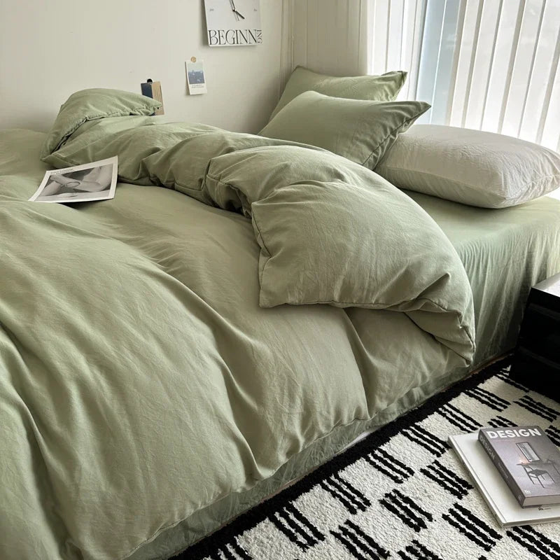 Bed with green bedding in a bedroom setting
