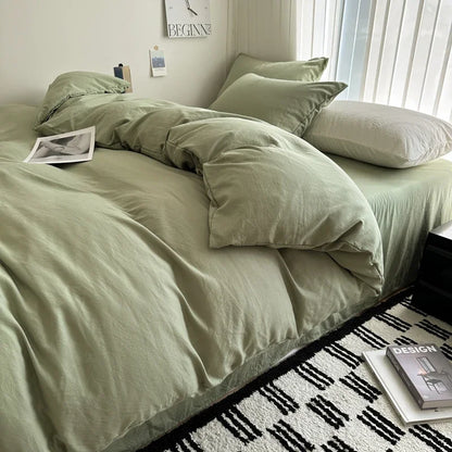 Bed with green bedding in a bedroom setting