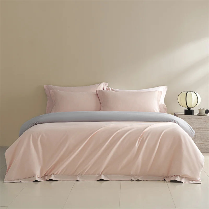 Pink bedding set on a bed with a neutral background