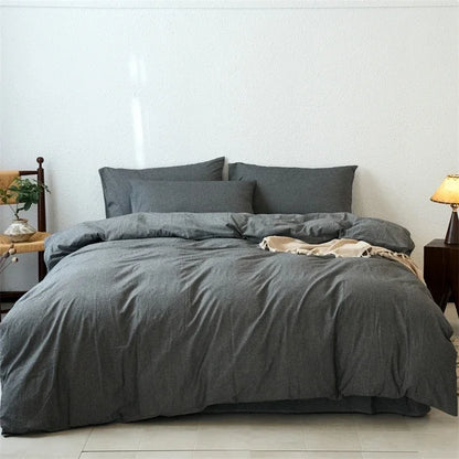 Gray bedding set on a bed in a minimalistic bedroom.