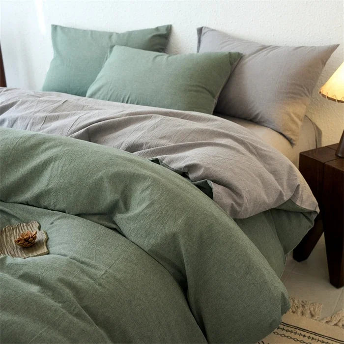Bed with green and gray bedding in a bedroom setting