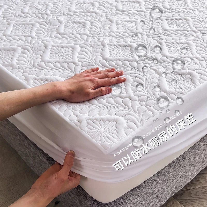 Mattress protector with hands touching it on a bed
