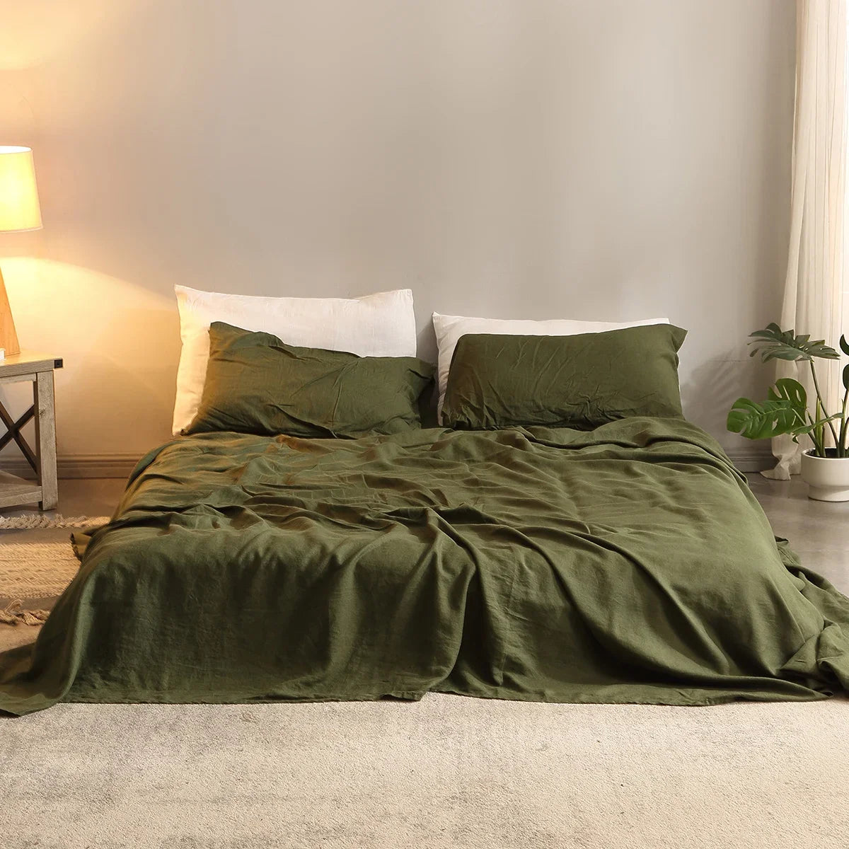 Bed with green bedding in a cozy bedroom setting