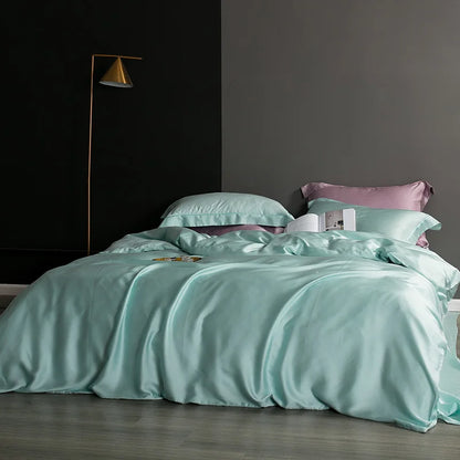 Teal bedding set on a bed with a dark wall and floor lamp in the background