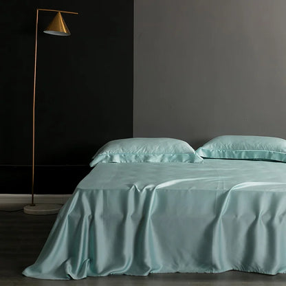 Teal bedspread and pillows on a bed in a darkly decorated room with a floor lamp.