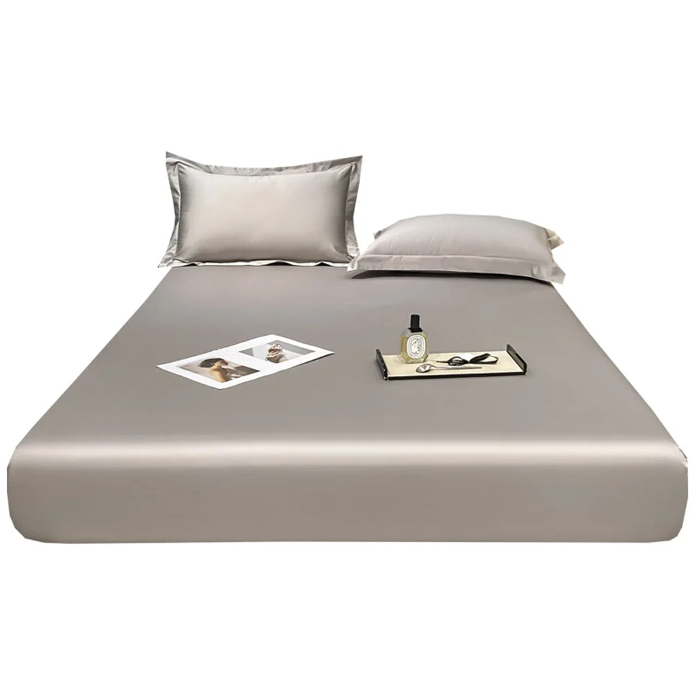 Beige bed sheet set with pillows on a white background