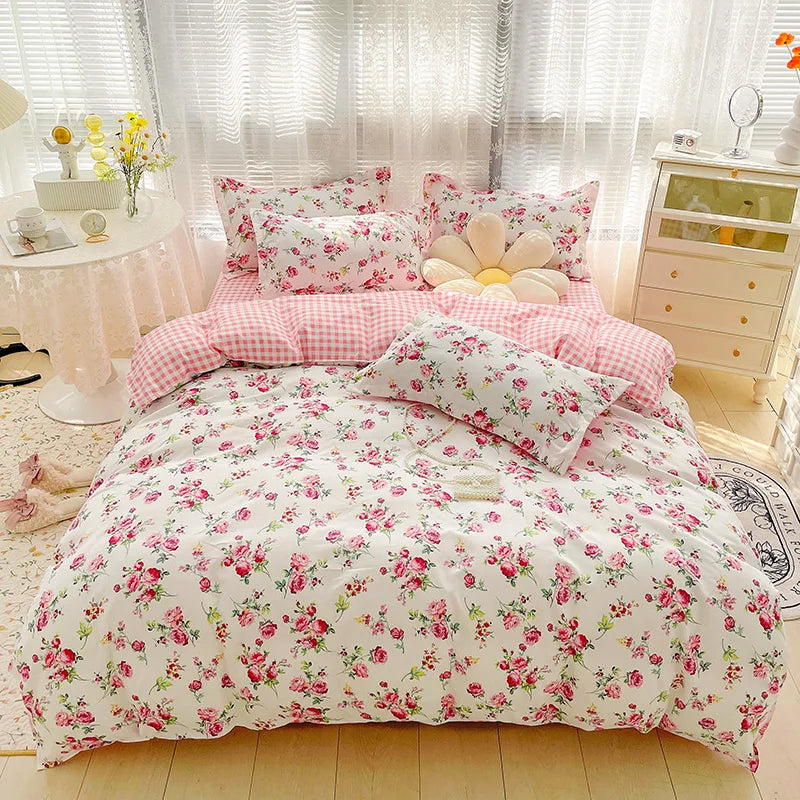 Floral bedding set on a bed in a bright bedroom with light-colored walls and furniture.