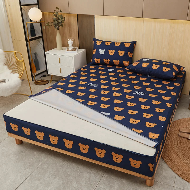 Bed with blue mattress cover featuring bear pattern in a room setting.