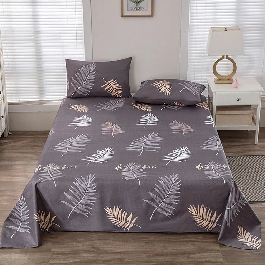 Gray leaf-patterned bedspread on a bed in a bedroom setting.