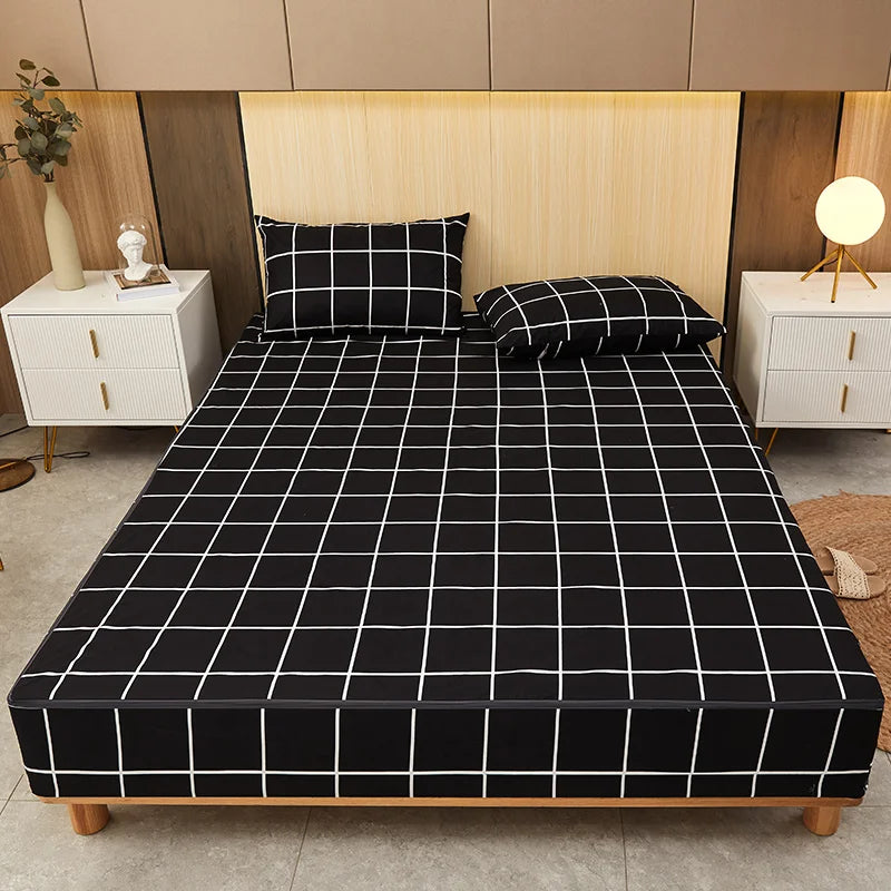 Bed with black grid patterned sheet and matching pillows in a bedroom setting.