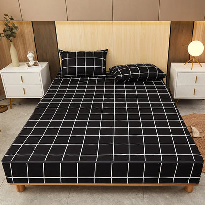 Bed with black grid patterned sheet and matching pillows in a bedroom setting.