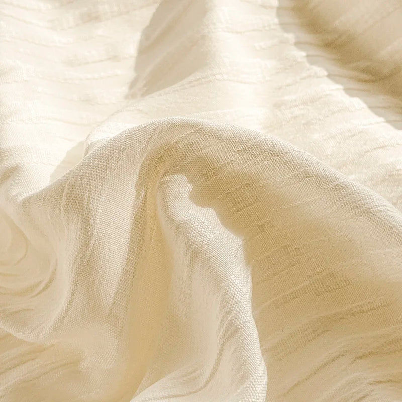Close-up of beige fabric with a subtle pattern