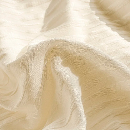 Close-up of beige fabric with a subtle pattern