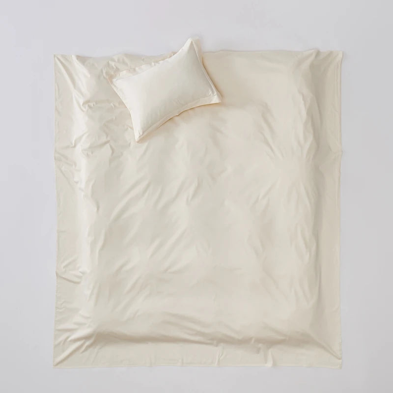 Beige bedding set with a pillow on a light gray background
