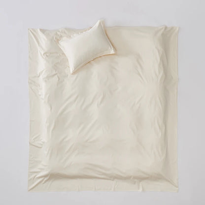 Beige bedding set with a pillow on a light gray background
