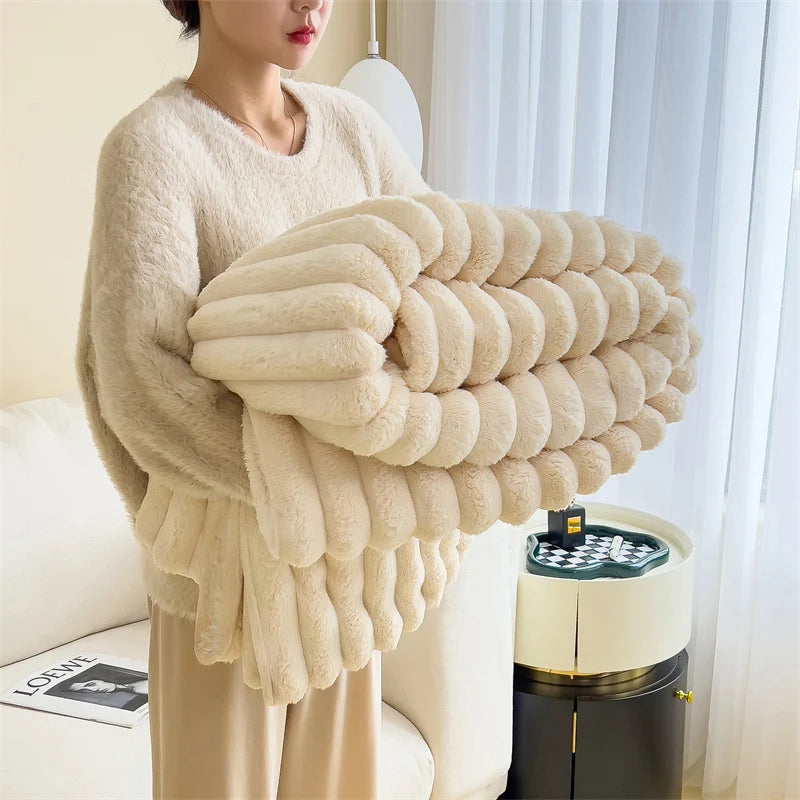 Person holding a large beige blanket in a cozy living room.