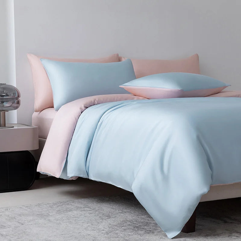 Bed with light blue and pink bedding in a bedroom setting
