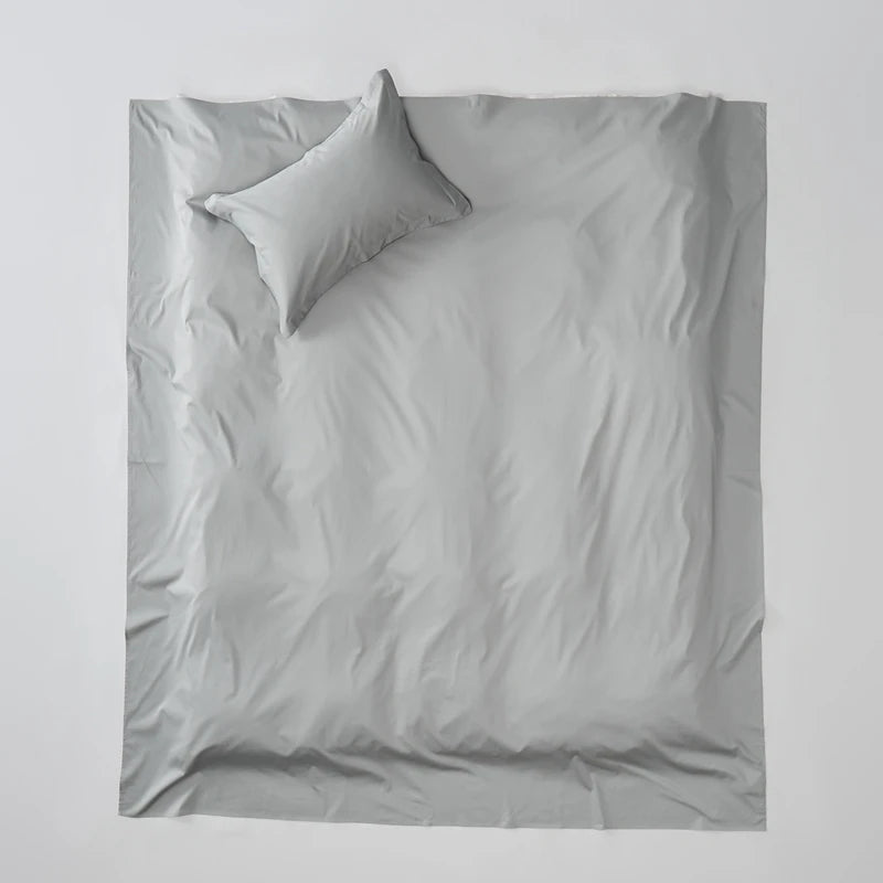 Gray bedding set with two pillows on a light gray background