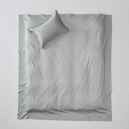 Gray bedding set with two pillows on a light gray background
