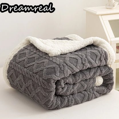 Gray textured blanket with white trim on a white surface, branded 'Dreamreal'.