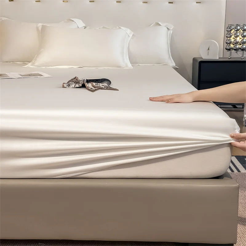 Person stretching a fitted sheet over a bed in a bedroom setting.