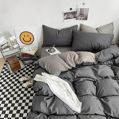 Gray bedding set on a bed with a checkered floor and decor items in the background.
