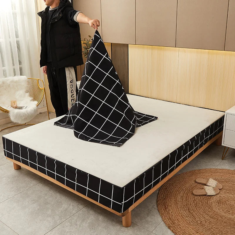 Person arranging a black and white checkered pillow on a bed in a bedroom.