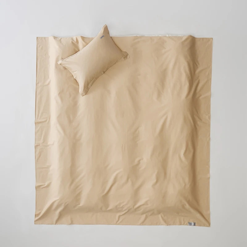 Beige duvet cover with matching pillow on a plain background
