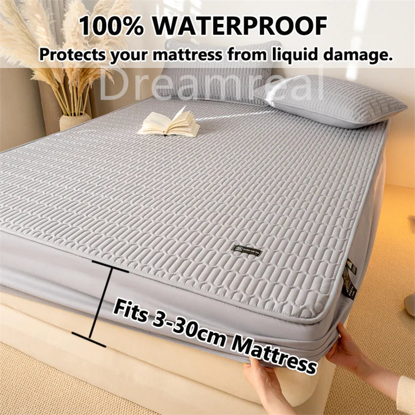 Gray mattress protector on a bed with text highlighting its waterproof feature and size compatibility.