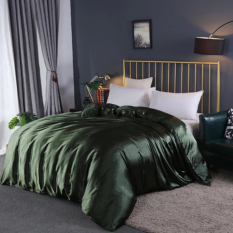 Bedroom with green bedding and gold headboard