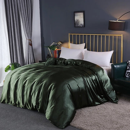 Bedroom with green bedding and gold headboard