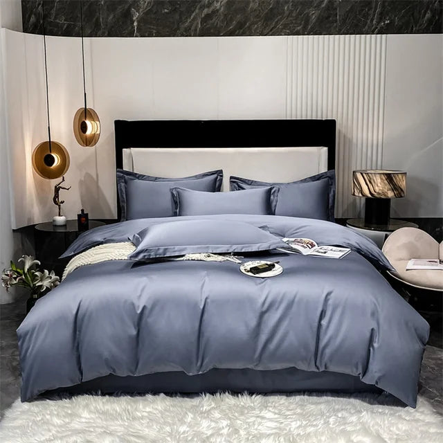 Gray bedding set on a bed in a modern bedroom with marble accents.