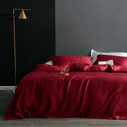 Bed with red bedding in a modern bedroom setting with a dark wall and gold floor lamp.