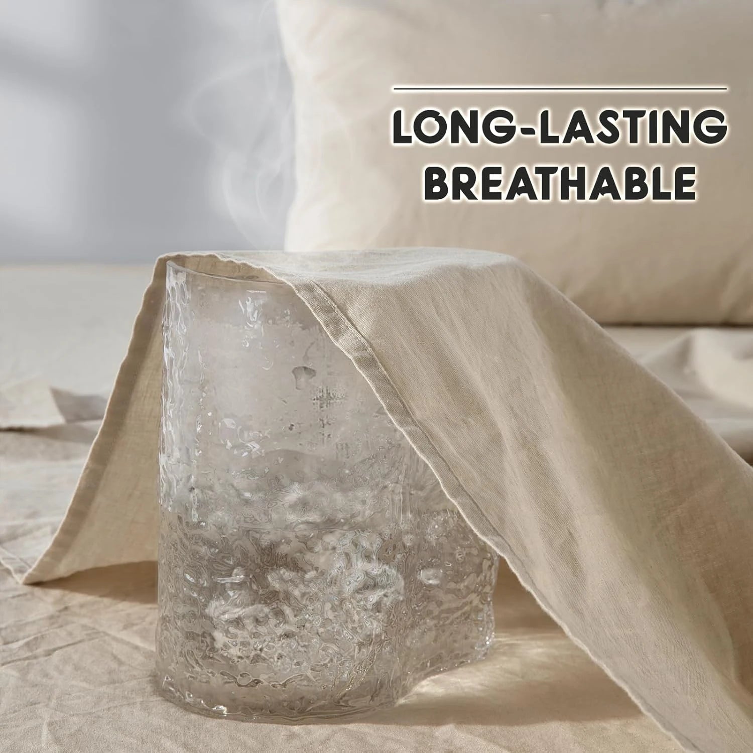 Text 'LONG-LASTING BREATHABLE' over a glass candle holder on a bed with beige bedding.