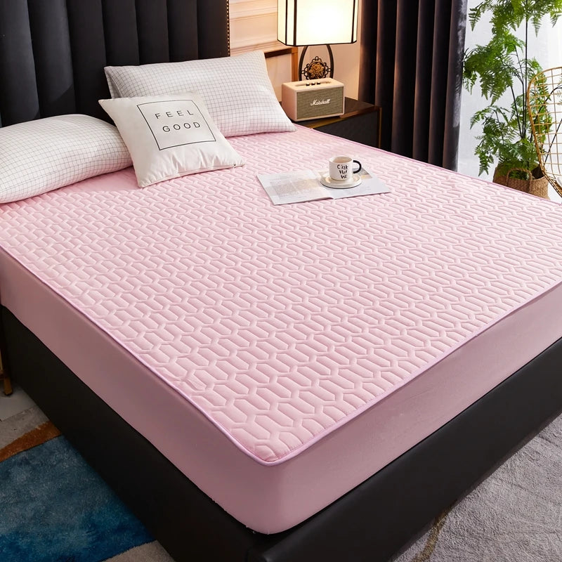 Pink mattress cover on a bed in a bedroom setting with pillows and a plant.