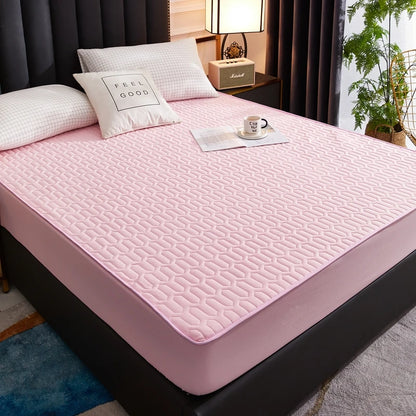 Pink mattress cover on a bed in a bedroom setting with pillows and a plant.