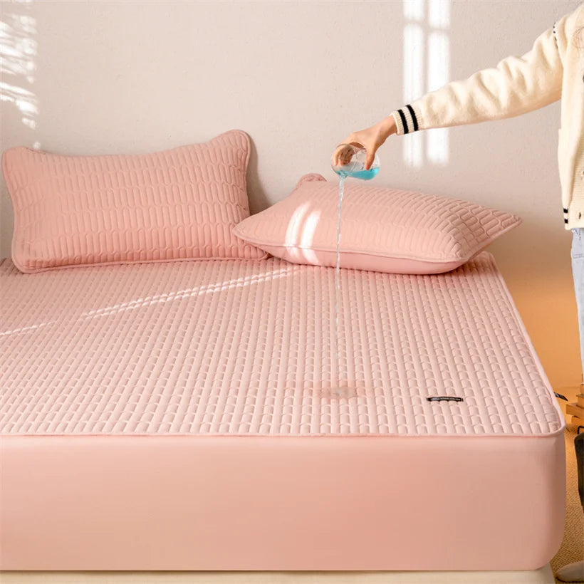 Person pouring water onto a pink mattress cover on a bed.
