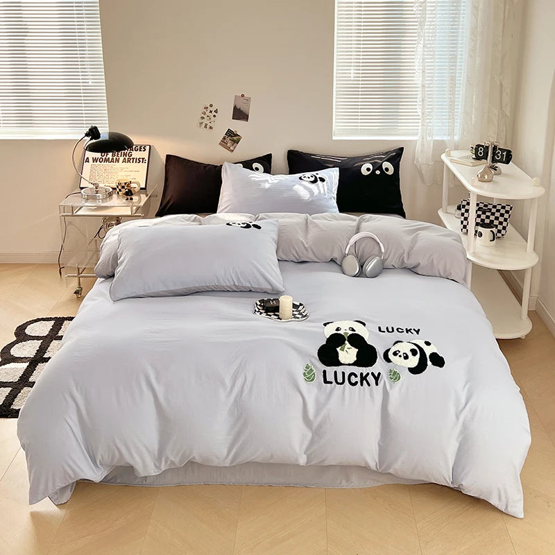 Bedroom with gray bedding featuring panda design and 'Lucky' text.