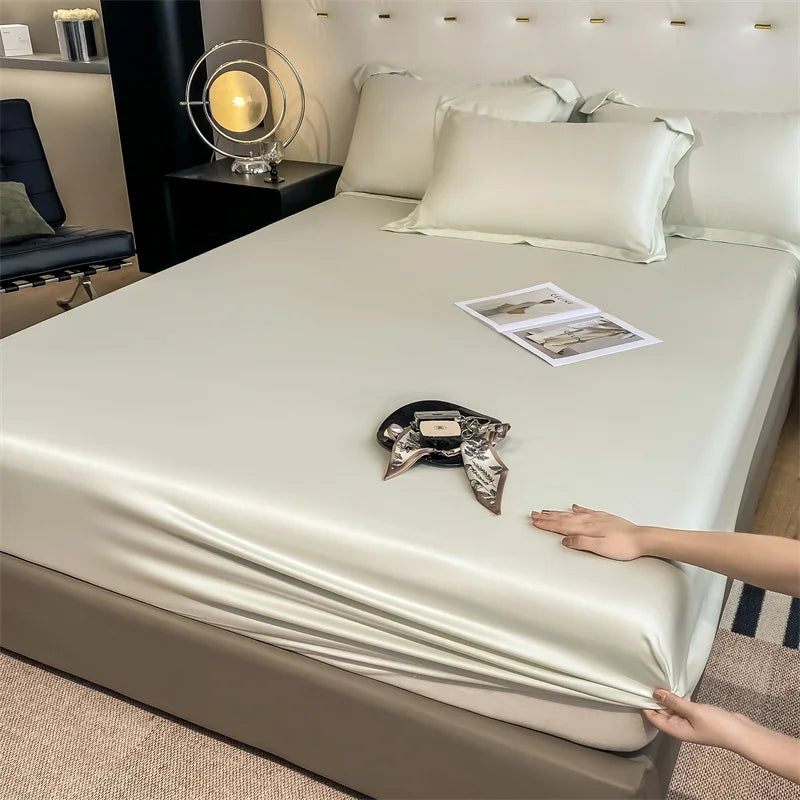 Person adjusting a satin sheet on a bed in a bedroom setting